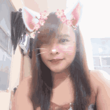 a woman with cat ears and flowers on her hair