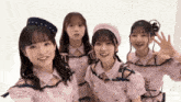 a group of young girls are posing for a picture and smiling