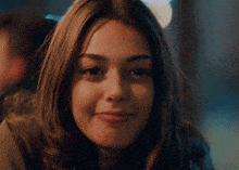 a close up of a woman 's face with a dark background