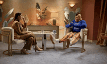 a man wearing a blue sweatshirt that says " i love you " sits next to a woman in a chair