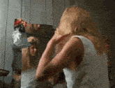 a woman looks at her reflection in a mirror
