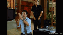 a gif from gifrun.com shows a man clapping his hands