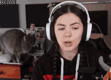 a woman wearing headphones with swiftmo written on the bottom right