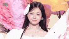 a woman in a white dress with a flower in her hair is on a mbc show
