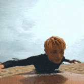 a man with orange hair is laying on a surfboard that says sss on it