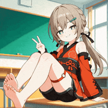 a girl is sitting on a desk and giving the peace sign
