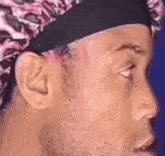 a close up of a man wearing a headband and a surgical cap .