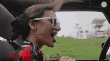 a woman wearing sunglasses is singing while driving a car and the word sayohara is on the bottom