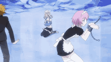 a woman in a maid outfit is chained to a man in a suit while another woman kneeling down .