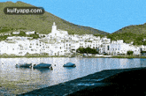 a picture of a lake with a village in the background and the website kulfyapp.com in the upper right corner