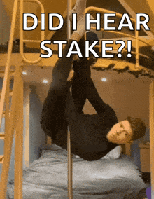 a man is hanging upside down on a pole with the caption did i hear stake ?