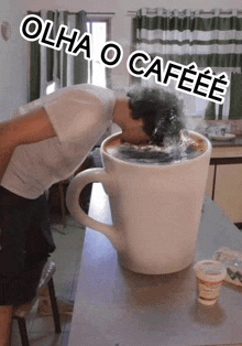 a man is drinking out of a giant coffee cup .