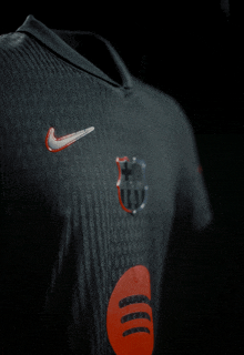 a close up of a black shirt with a nike logo on the front