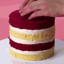 a red velvet cake with yellow frosting on top