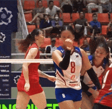 a female volleyball player wearing a number 8 jersey