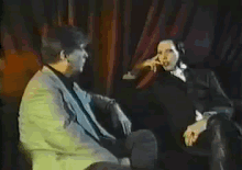 a man and a woman are sitting next to each other and talking