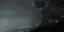 a black and white photo of a person in a dark room .