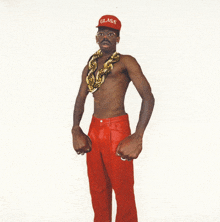 a shirtless man wearing a red hat with the word glass on it