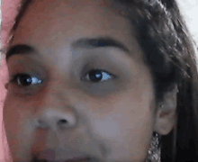 a close up of a woman 's face with her eyes looking at the camera