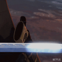 a person holding a sword with a netflix logo on the bottom right