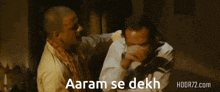 two men are fighting with the words aaram se dekh in the corner