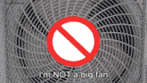 a sign that says i 'm not a big fan is above a fan