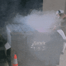 a man wearing headphones sits in front of a dumpster that says " fighter " on it