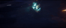 a woman is sitting in a dark room with a glowing light coming out of her head