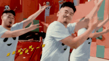 a group of men are dancing in front of a red car with chinese writing on the side