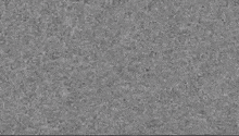 a close up of a gray surface with a lot of small dots on it