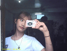 a girl is taking a picture of herself in a mirror on a date of 2025/06/21