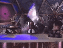 a robot is flying through the air in a futuristic room .