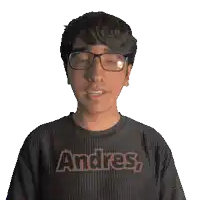 a man wearing glasses and a black shirt that says andres on it