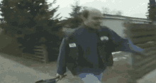 a man wearing a vest that says ' mt ' on it is walking down the street