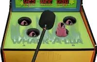 a whack-a-lua arcade game with a microphone in the middle