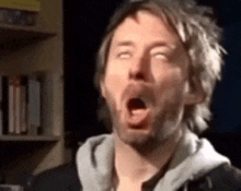 a man with his mouth open and his eyes closed .