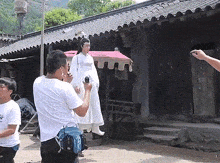 a man taking a picture of a woman with a camera