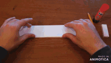 a stick of glue sits on a table next to a pencil