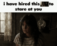 a girl in a dark room with the words i have hired this to stare at you