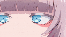 a close up of a girl 's blue eyes with a purple fringe