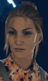 a close up of a woman 's face with a floral shirt