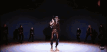 a group of people are dancing in a dark room on a stage .