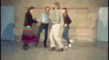 a blurry picture of a group of people dancing in a hallway