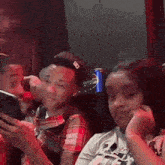 a group of young people are sitting in front of a can of pepsi