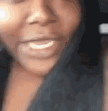 a close up of a woman 's face with her mouth open and a slight smile on her face .