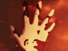 a hand with blood on it is reaching out towards something