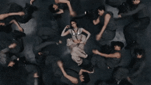 a group of people are laying on their stomachs in a dark room