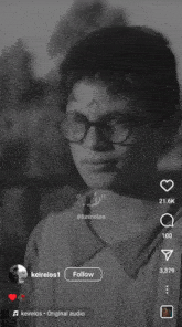 a black and white photo of a boy wearing glasses with arabic writing on it