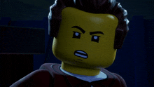 a close up of a lego man 's face with his eyes closed and a sad look on his face