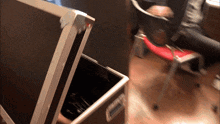 a person is sitting in a chair next to a briefcase that says ' d ' on the bottom
